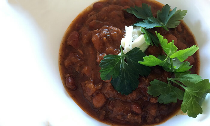 Black bean chili with vegan cheese and cilantro toppings