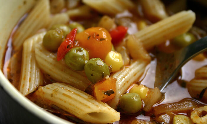 Close up of minestrone soup with noodles