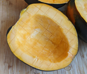 Acorn squash cut in half and scored