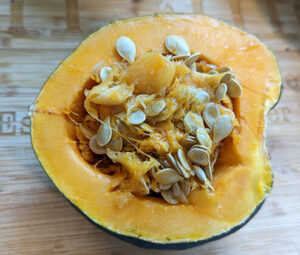 Acorn squash cut in half and full of seeds