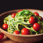 Zucchini noodles with pesto and cherry tomatoes in a bowl
